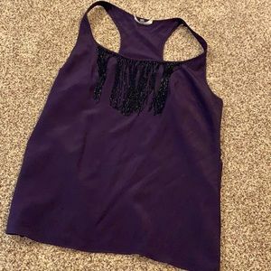 Purple tank with black fringe detail.
